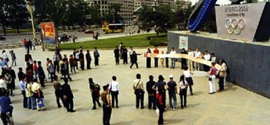 opening the big red book at the olympic taiji logo at Wangfujing, showing the signatures of 2008 laowai